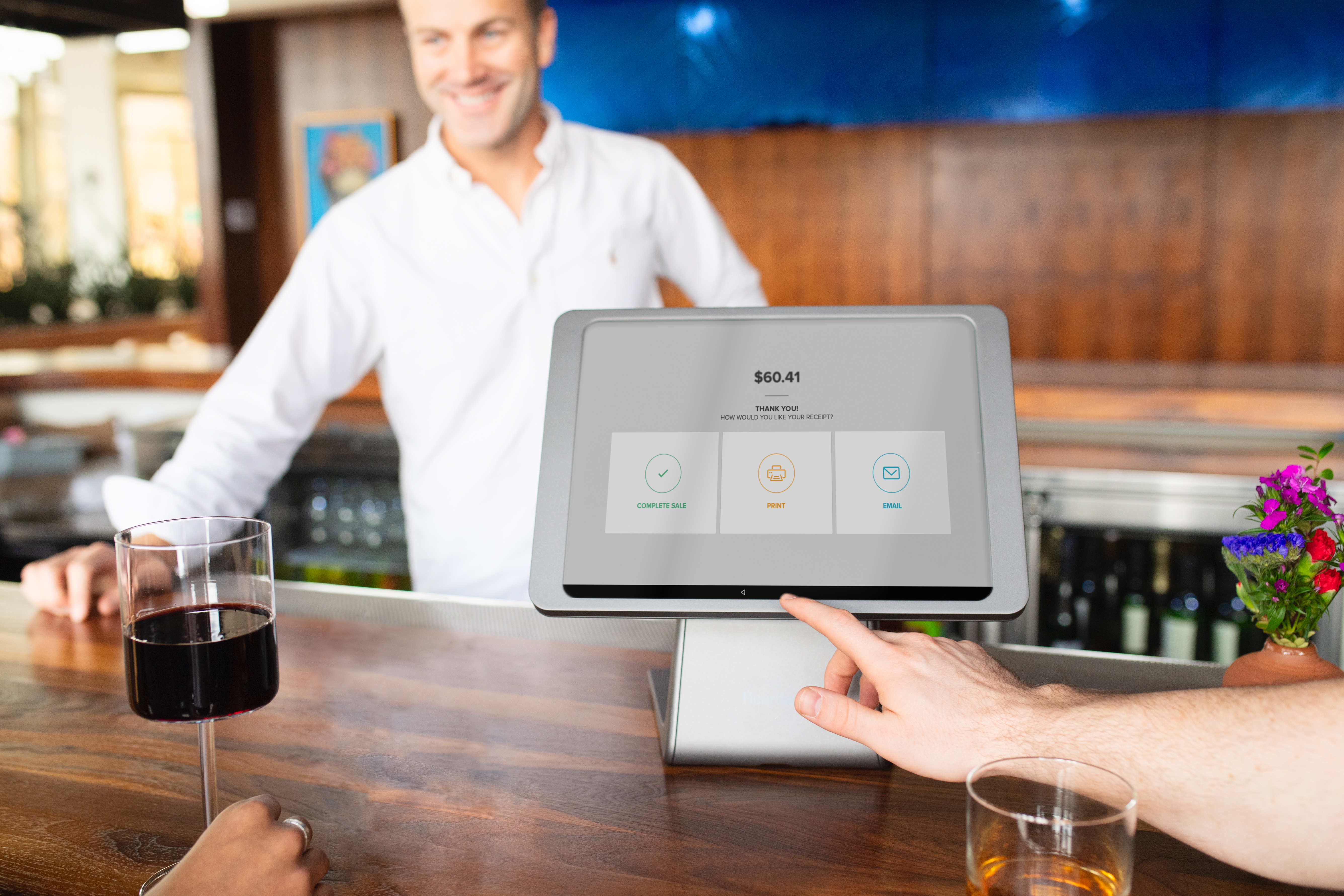 Point of sales system on register with cafe and bar background