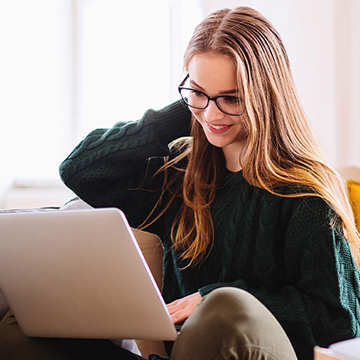 Happy lady reading laptop computer